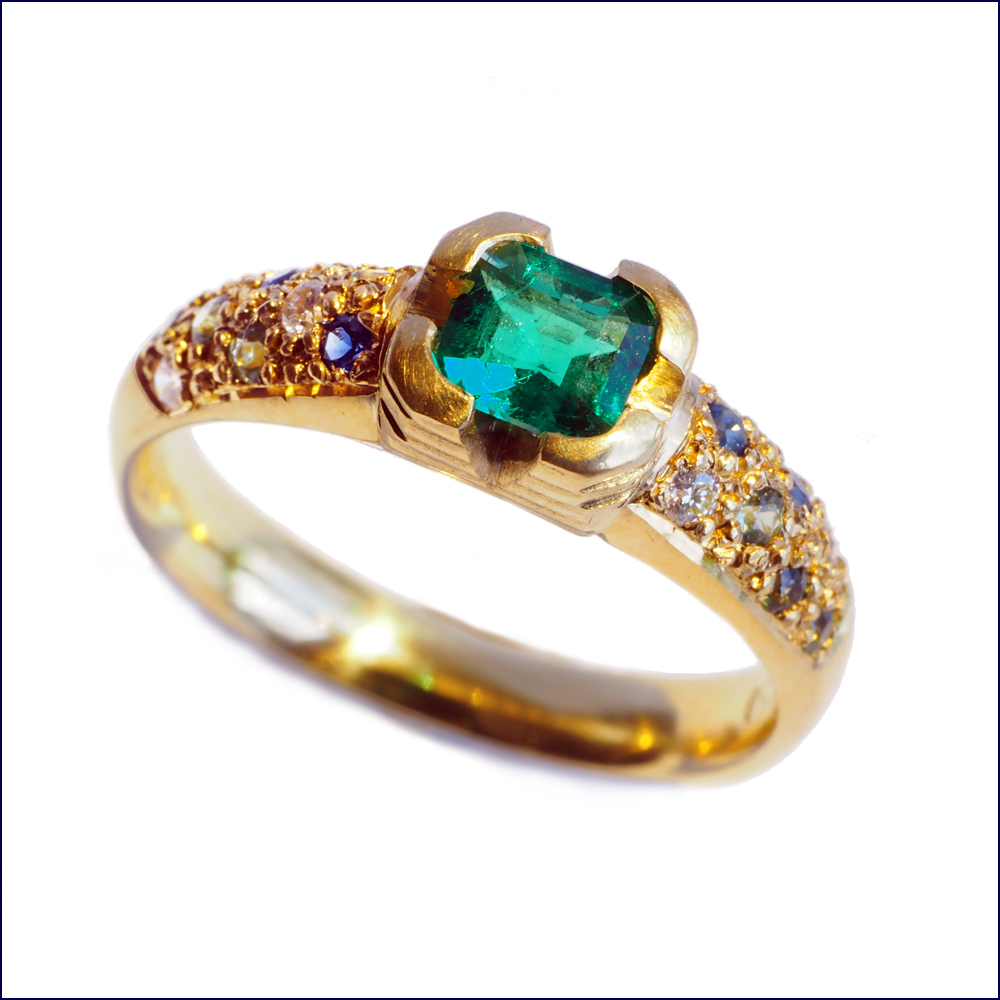 Allison's emerald, diamond and Australian sapphire engagement ring.