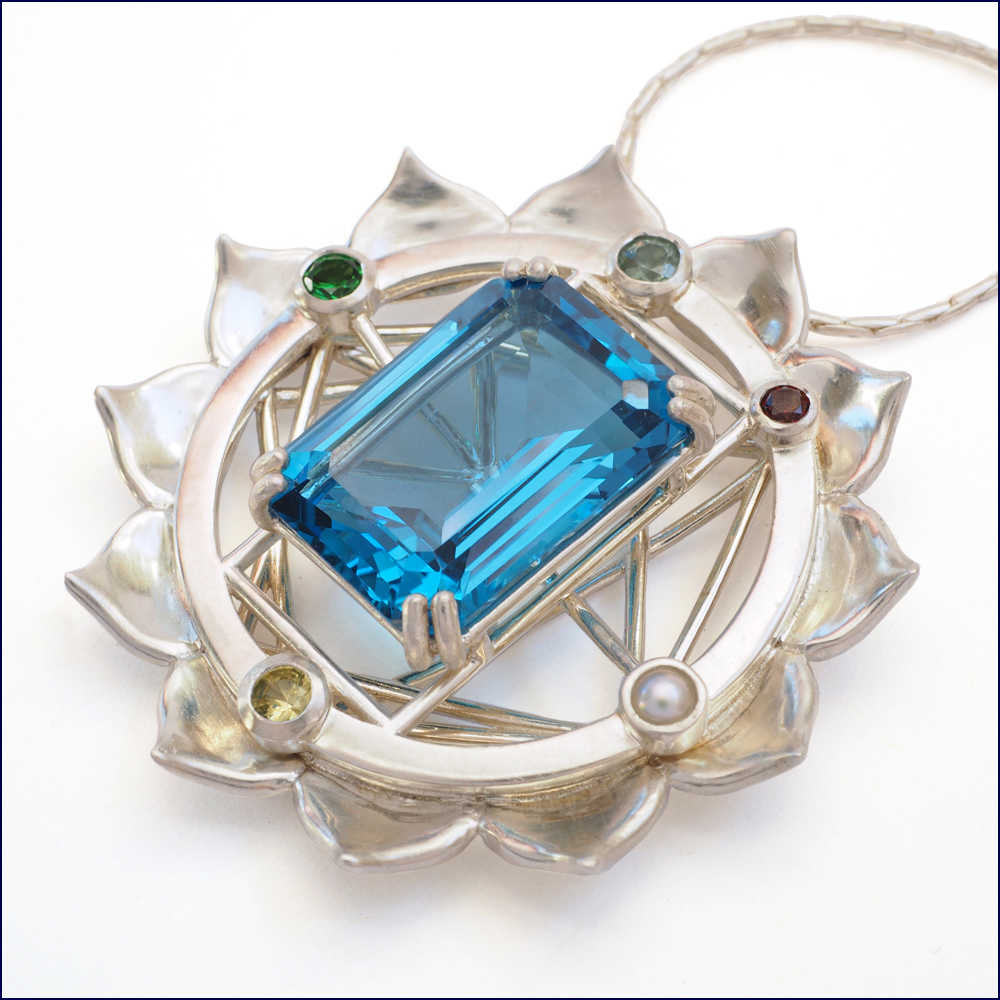 Yantra pendant with London topaz and assorted gems set in sterling silver.